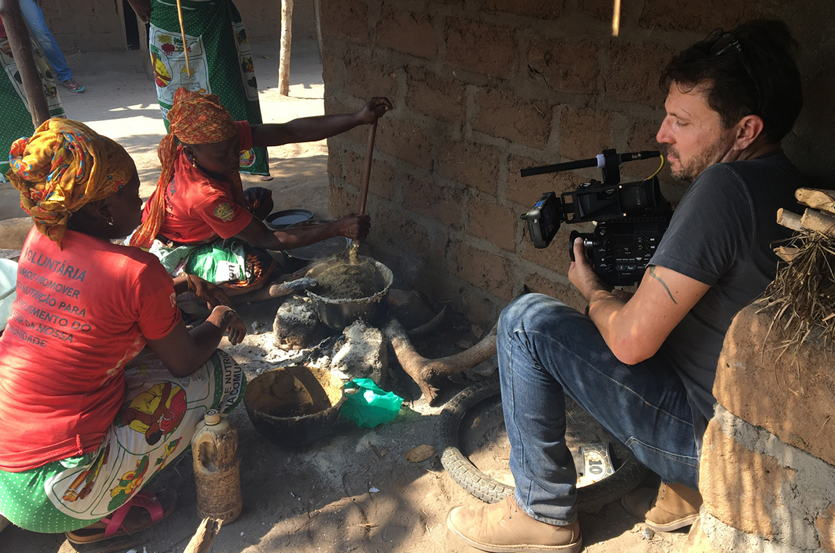 Christoph on location, shooting a group of women cooking in Africa